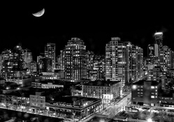 moon over a city in black and white