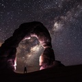 delicate natural arch under starry sky