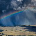 panoramic view of a rainbow in a rain shower