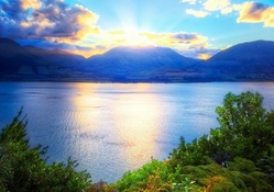 sunrise over mountains above a lake hdr
