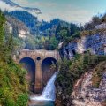 waterfall by a dam in a mountain gorge hdr