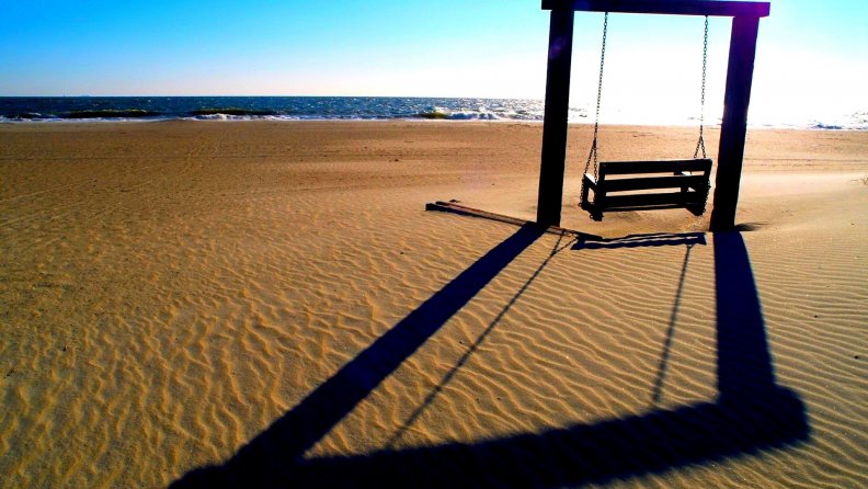 beach swing casts a long shadow