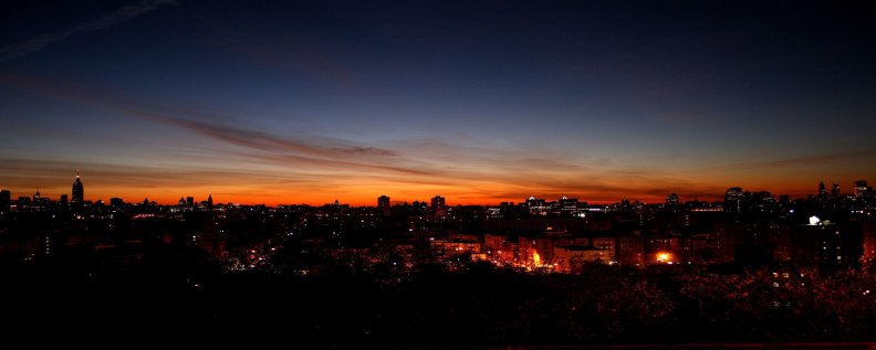 panoramic_view_of_a_city_at_dusk.jpg