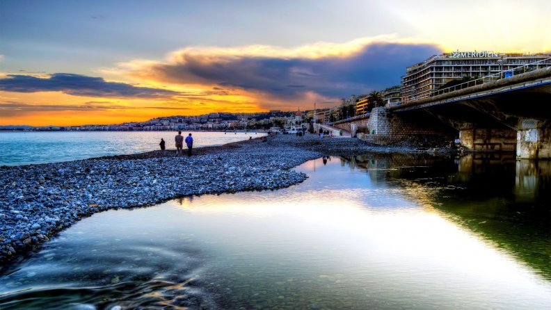 a walk on a beach in a seaside town at sunset hdr