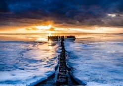ice on seashore at sunset