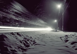light from a winter road embankment in long exposure