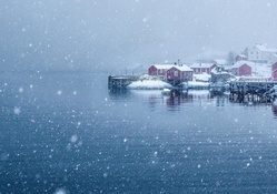 snow storm over norwegian seaside village