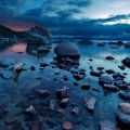 stones strewn on a lake shore 