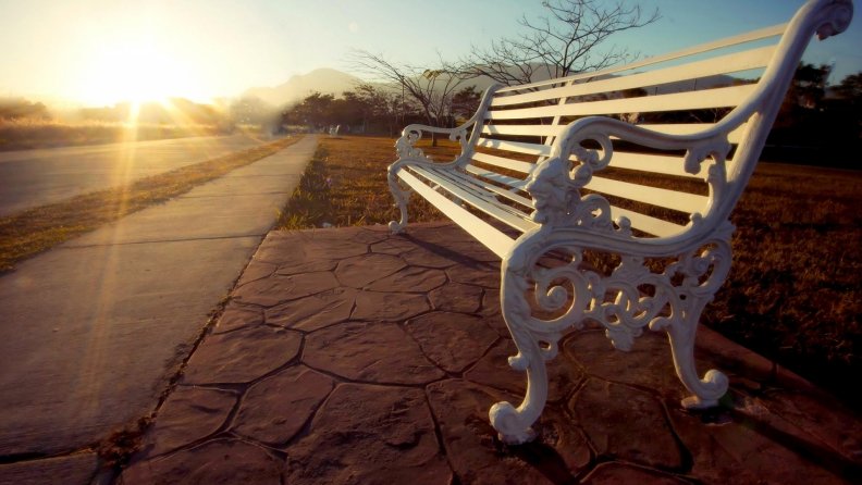 bright sunrise on a street bench