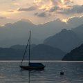 sailboat on an alpine lake at sundown