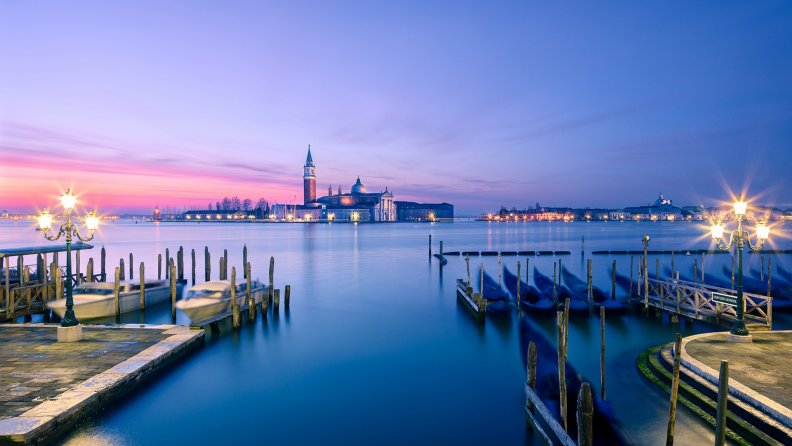 boat piers across the lagoon from venice at sunset