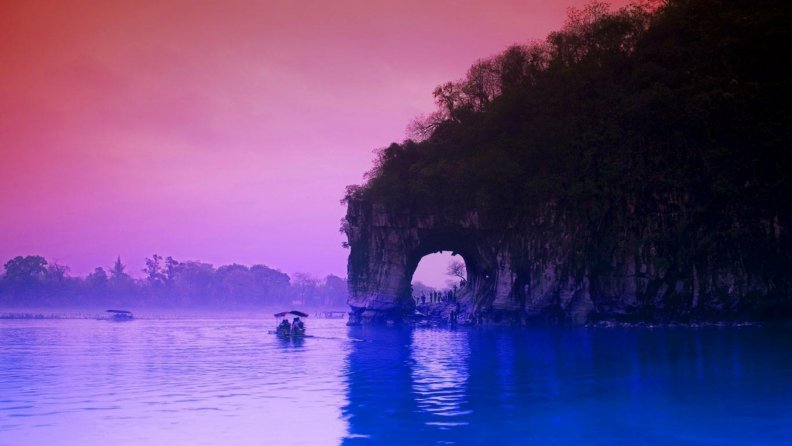 arched cliff on a river in china at dusk