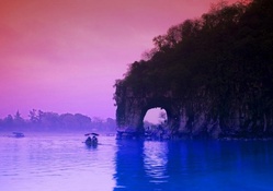 arched cliff on a river in china at dusk