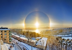 a solar halo over a city in winter