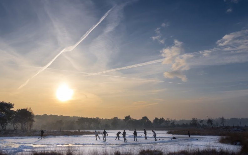 playing hockey on a frozen pond