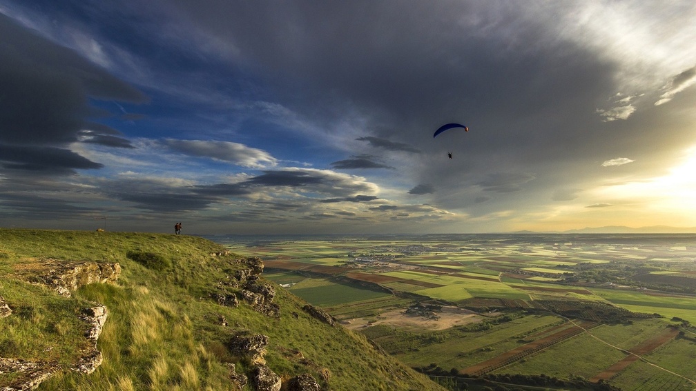 parachute skydiving into a beautiful valley