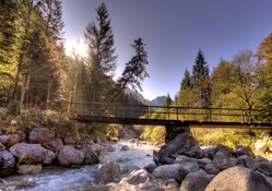 foot bridge over rocky mountain river hdr
