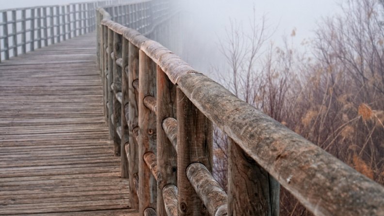wooden rail in a bridge in fog hdr