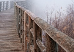 wooden rail in a bridge in fog hdr
