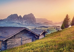 wooden cabins on an alpine meadow in morning hdr