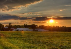 sunset over a farm in spring