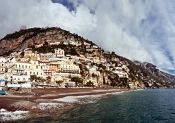 cloud covered positano on the seaside