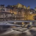 castle above a flowing river at night hdr