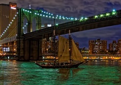 sailboat under brooklyn bridge at night hdr