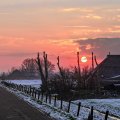 road through farmlands at sunrise