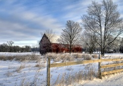 red barn on a farm in winter
