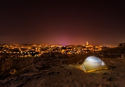 camping outside a desert city at night