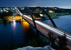 arched steel bridge at night in long exposure