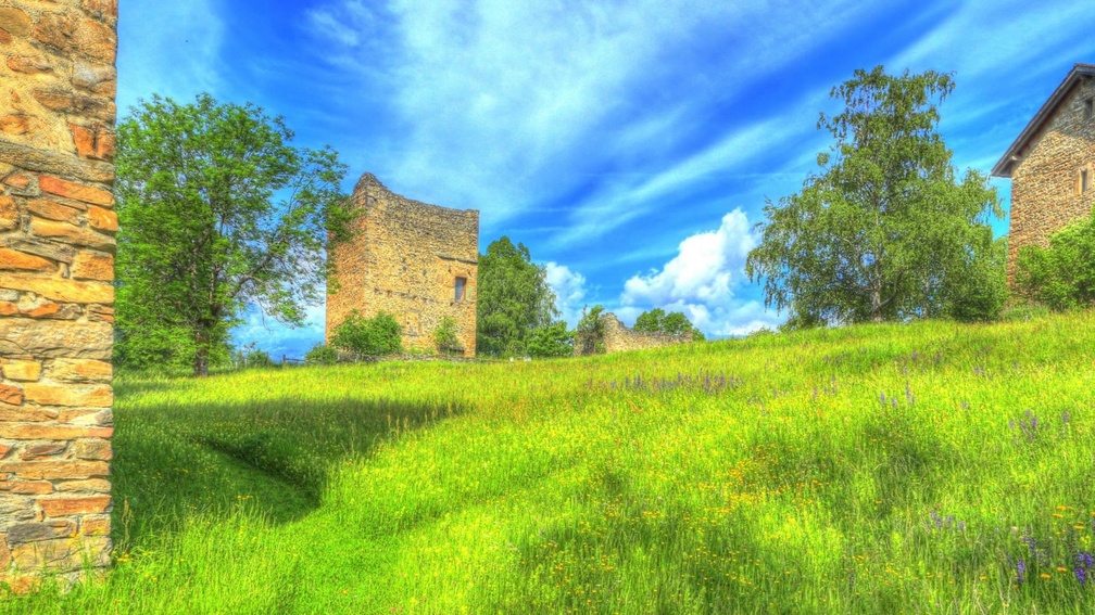 castle ruins on a grassy hill hdr