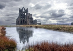 whitby abbey ruins by a pond hdr