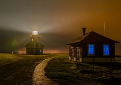 a bright lighthouse on a foggy night