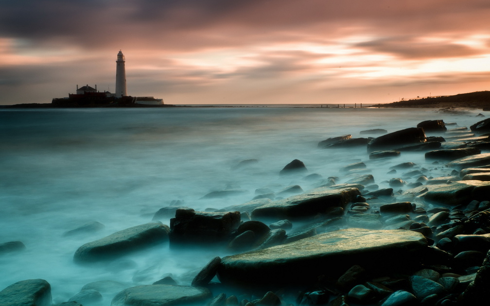 lighthouse on an island in a misty sea