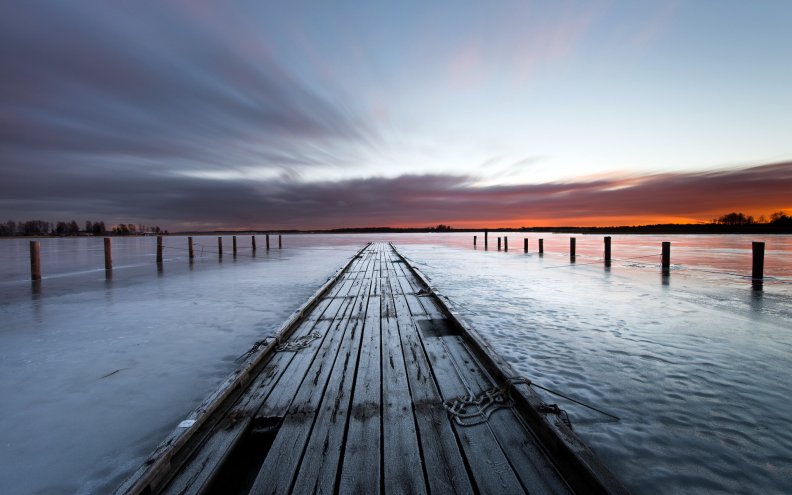 old wooden pier on a lake at sundown