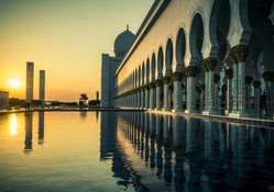 the grand mosque in abu dhabi at sunset