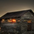 wonderful sunset through a wooden hut hdr