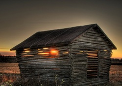 wonderful sunset through a wooden hut hdr