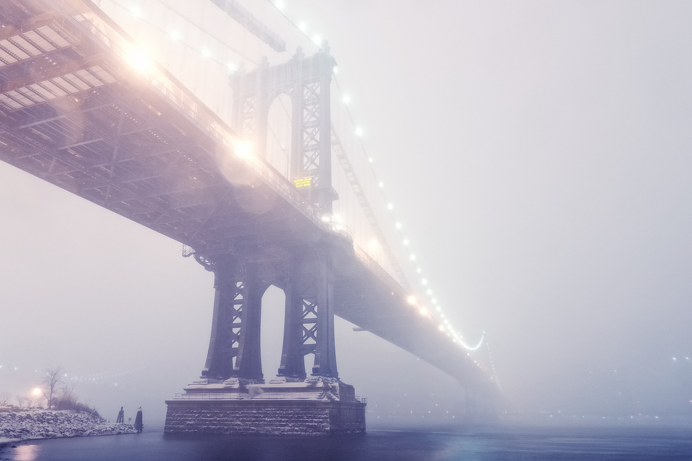 magnificent manhattan bridge in a winter fog