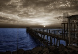 pier on blue sea and gray sky