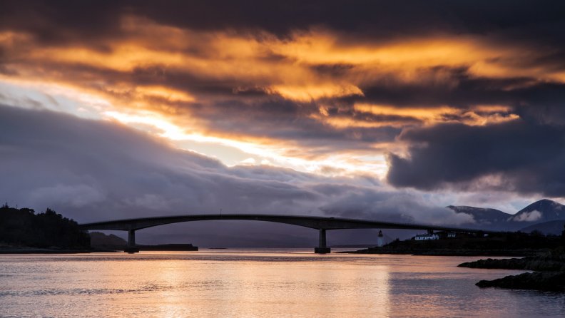 skye bridge in scotland under fiery sky