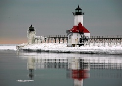 dual lighthouses on an icy pier