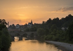 bridge in a lovely town at sunset