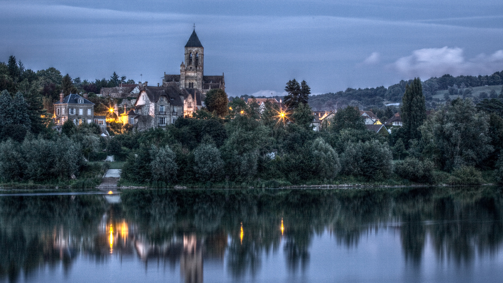 church in vtheuil outside paris reflected in river hdr
