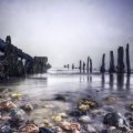 pier ruins on a rocky shore hdr