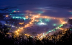 town at night under winter fog
