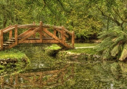 lovely wooden bridge on a garden pond