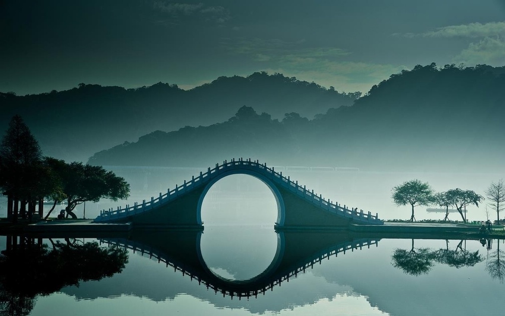 fantastic bridge on misty lake